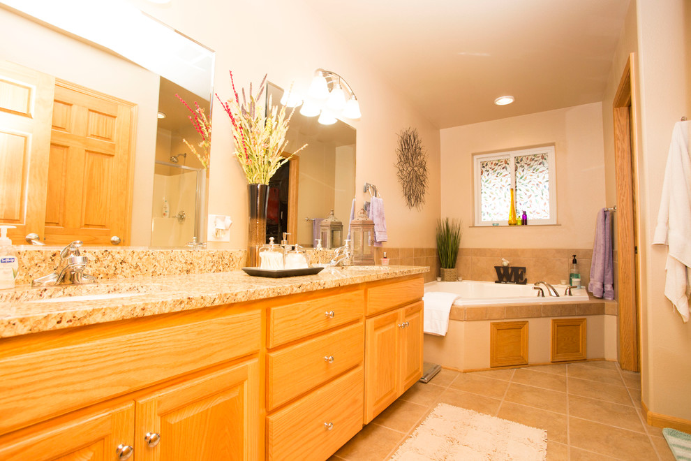 Bathroom - large transitional master beige tile bathroom idea with raised-panel cabinets, light wood cabinets and granite countertops
