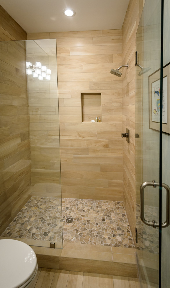 Photo of a mid-sized beach style 3/4 bathroom in Charleston with flat-panel cabinets, an alcove shower, a one-piece toilet, beige tile, porcelain tile, porcelain floors, an undermount sink, quartzite benchtops, beige floor, a hinged shower door and yellow cabinets.