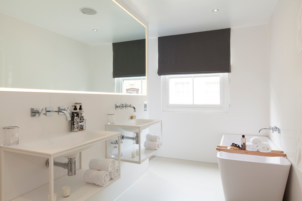 Example of a mid-sized trendy master ceramic tile freestanding bathtub design in London with a wall-mount sink, open cabinets, white cabinets and white walls