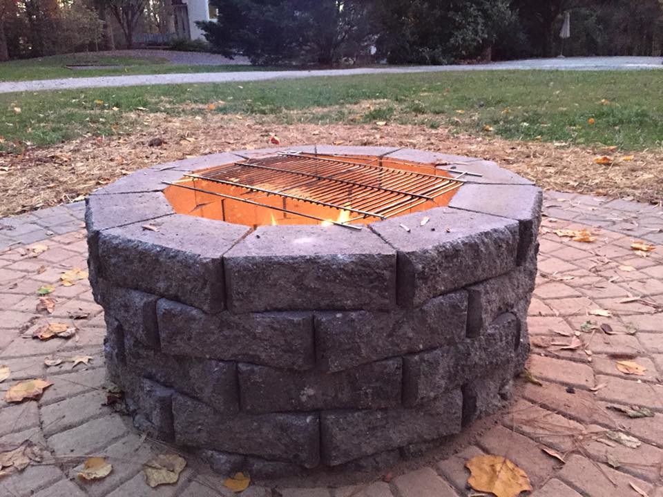 Inspiration for a large transitional partial sun backyard stone landscaping in Richmond with a fire pit for fall.