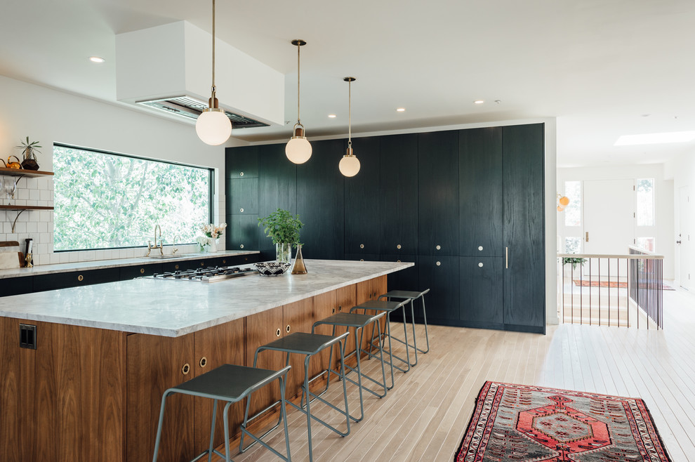 Large eclectic l-shaped open plan kitchen in Salt Lake City with a drop-in sink, flat-panel cabinets, green cabinets, marble benchtops, white splashback, ceramic splashback, coloured appliances, light hardwood floors and with island.