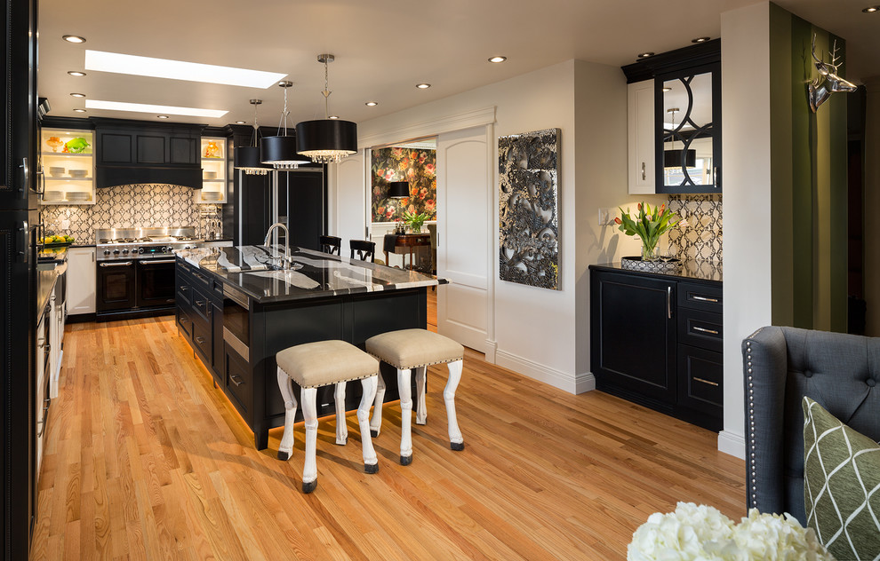 Photo of an eclectic kitchen in Vancouver with black appliances.