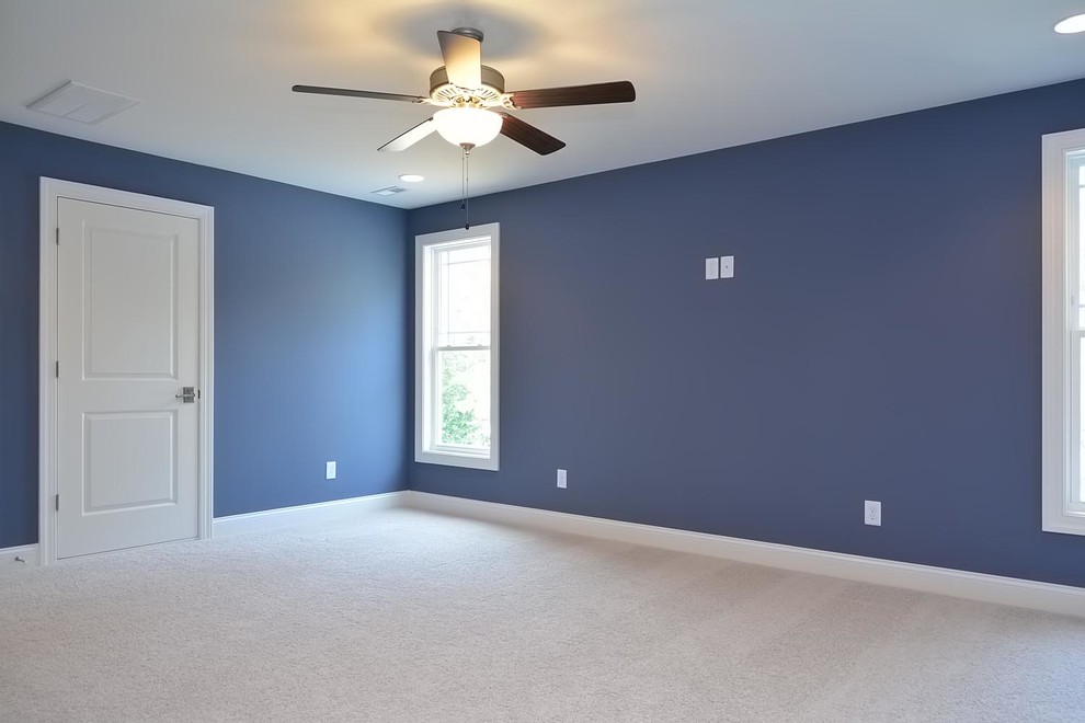 Inspiration for a large arts and crafts enclosed home theatre in Raleigh with blue walls and carpet.