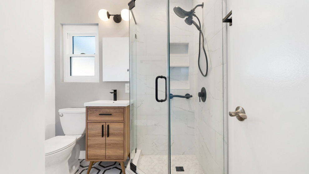 Expansive bathroom in Los Angeles with a one-piece toilet and a hinged door.