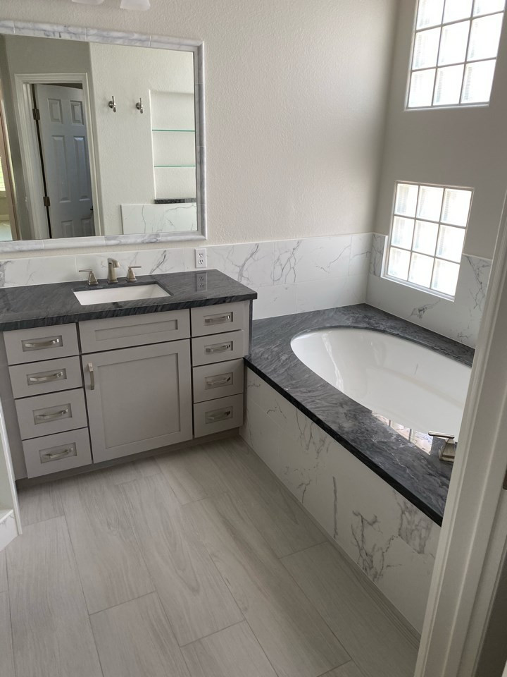 Example of a large minimalist black and white tile and porcelain tile porcelain tile, gray floor and double-sink bathroom design in Phoenix with shaker cabinets, gray cabinets, white walls, an undermount sink, quartz countertops, a hinged shower door, black countertops and a built-in vanity