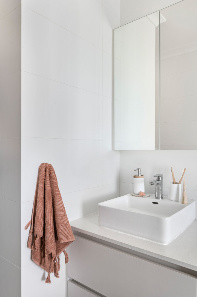 Contemporary wet room bathroom in Perth with a corner tub, white tile, porcelain floors, a vessel sink, engineered quartz benchtops, an open shower, a single vanity and a built-in vanity.