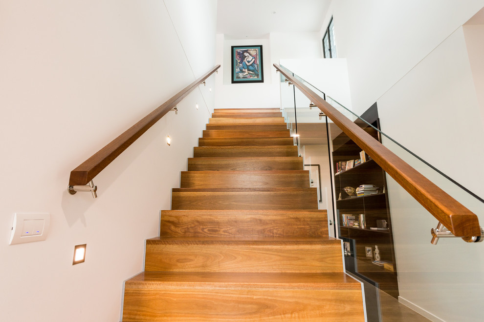 Contemporary wood straight staircase in Sunshine Coast with wood risers.
