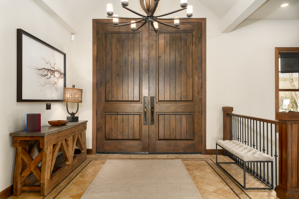 This is an example of a mid-sized country front door in Seattle with white walls, bamboo floors, a double front door and a dark wood front door.