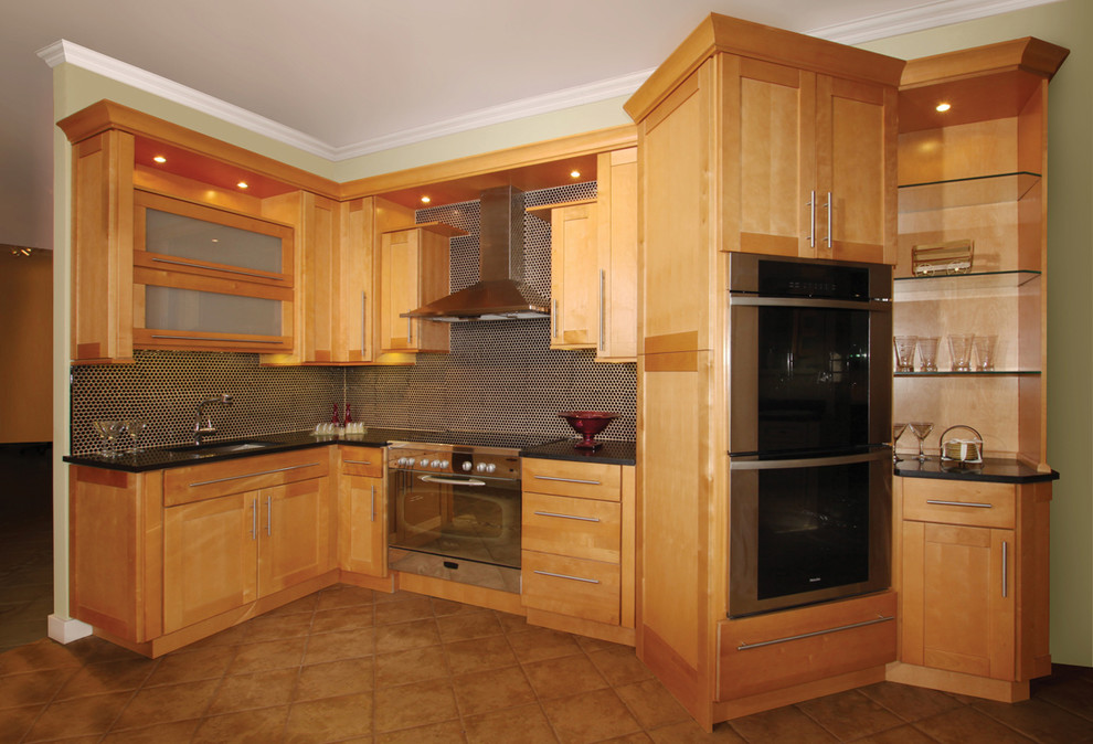 Mid-sized transitional l-shaped ceramic tile eat-in kitchen photo in Philadelphia with an undermount sink, recessed-panel cabinets, medium tone wood cabinets, granite countertops, black backsplash, subway tile backsplash, stainless steel appliances and no island