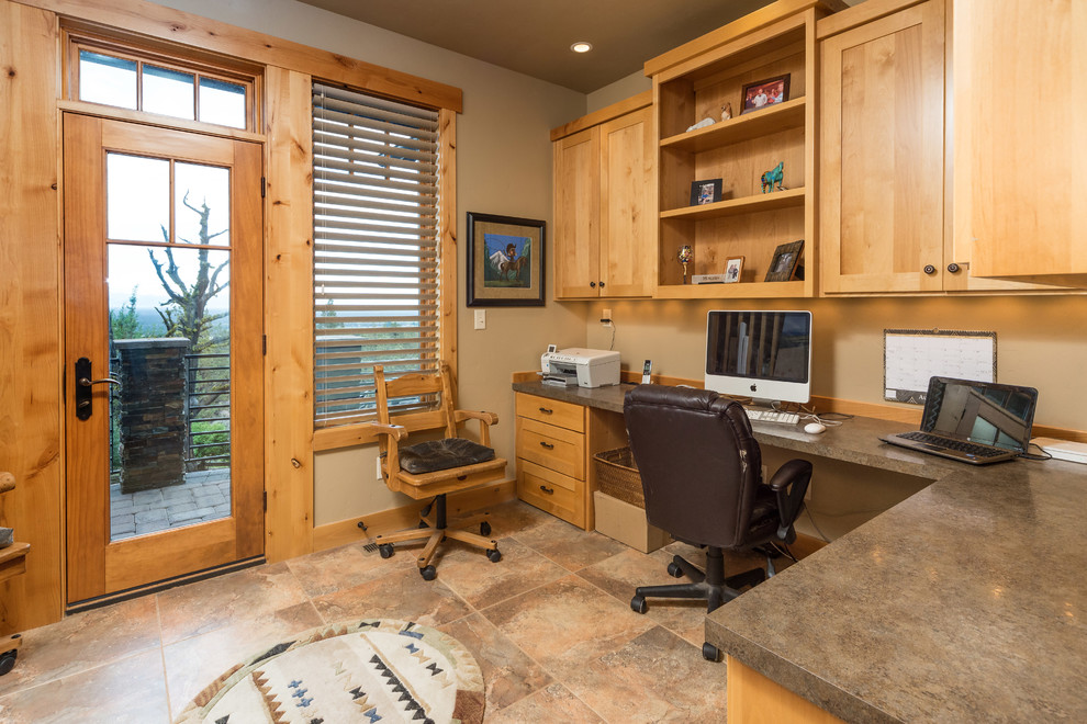 Country home office in Other with beige walls and a built-in desk.