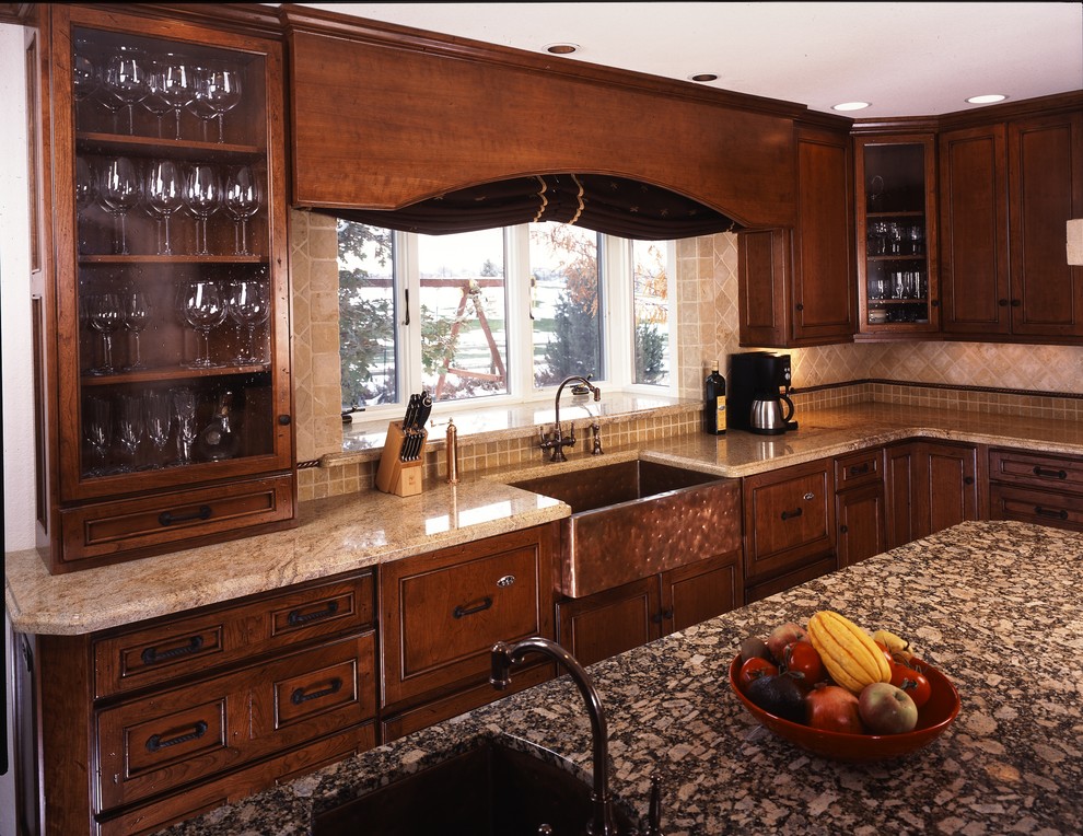 Design ideas for a large traditional u-shaped open plan kitchen in Denver with a farmhouse sink, raised-panel cabinets, dark wood cabinets, granite benchtops, beige splashback, ceramic splashback, stainless steel appliances and ceramic floors.