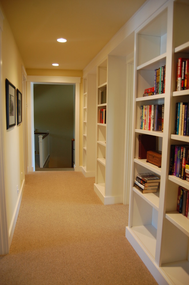 Mid-sized traditional hallway in Bridgeport with yellow walls and carpet.