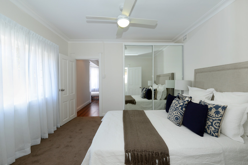 Photo of a large contemporary guest bedroom in Sydney with white walls and carpet.