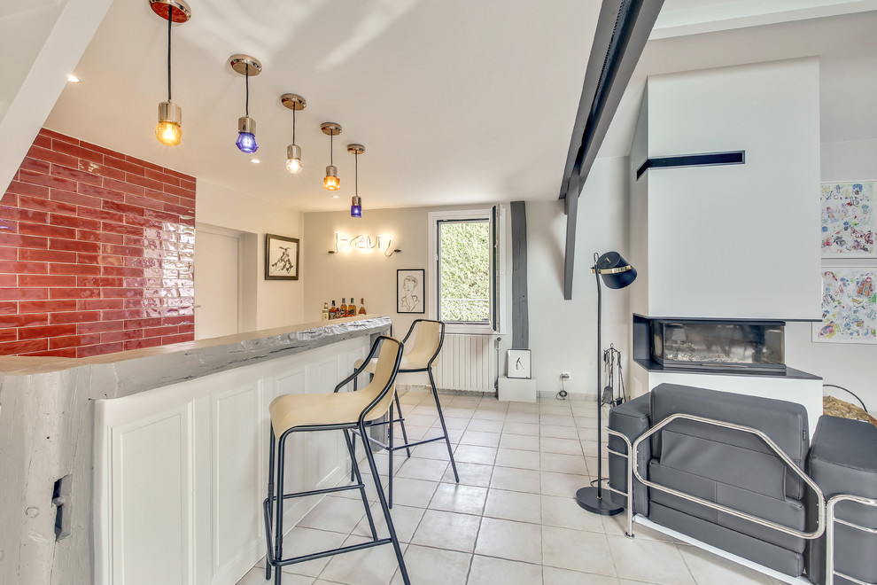 This is an example of a large contemporary seated home bar in Paris with an integrated sink, light wood cabinets, red splashback, terra-cotta splashback, ceramic floors and beige floor.