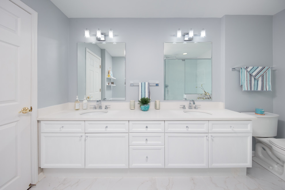 Photo of a mid-sized contemporary master wet room bathroom in Chicago with flat-panel cabinets, white cabinets, a drop-in tub, a one-piece toilet, beige walls, marble floors, an undermount sink, engineered quartz benchtops, white floor and a sliding shower screen.
