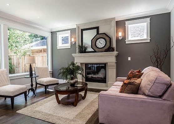 Example of a mid-sized trendy formal and enclosed dark wood floor and brown floor living room design in Vancouver with white walls, a standard fireplace, a concrete fireplace and no tv