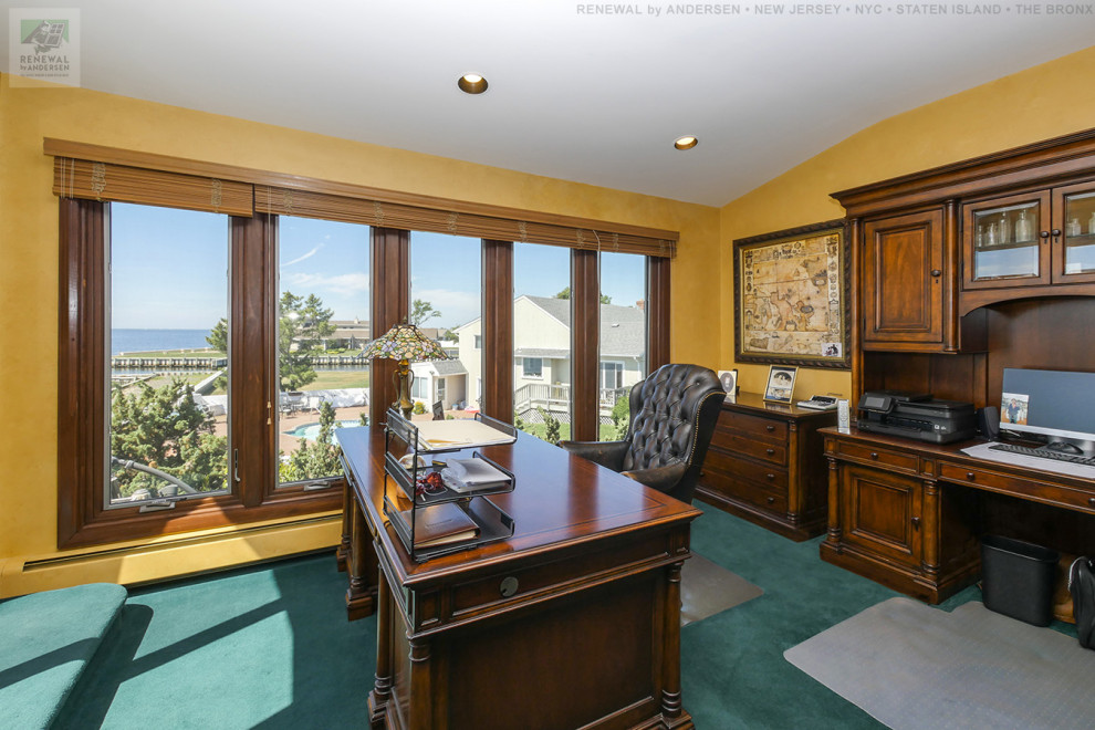 Large home office in Newark with yellow walls, carpet, no fireplace, a freestanding desk, green floor, vaulted and wallpaper.