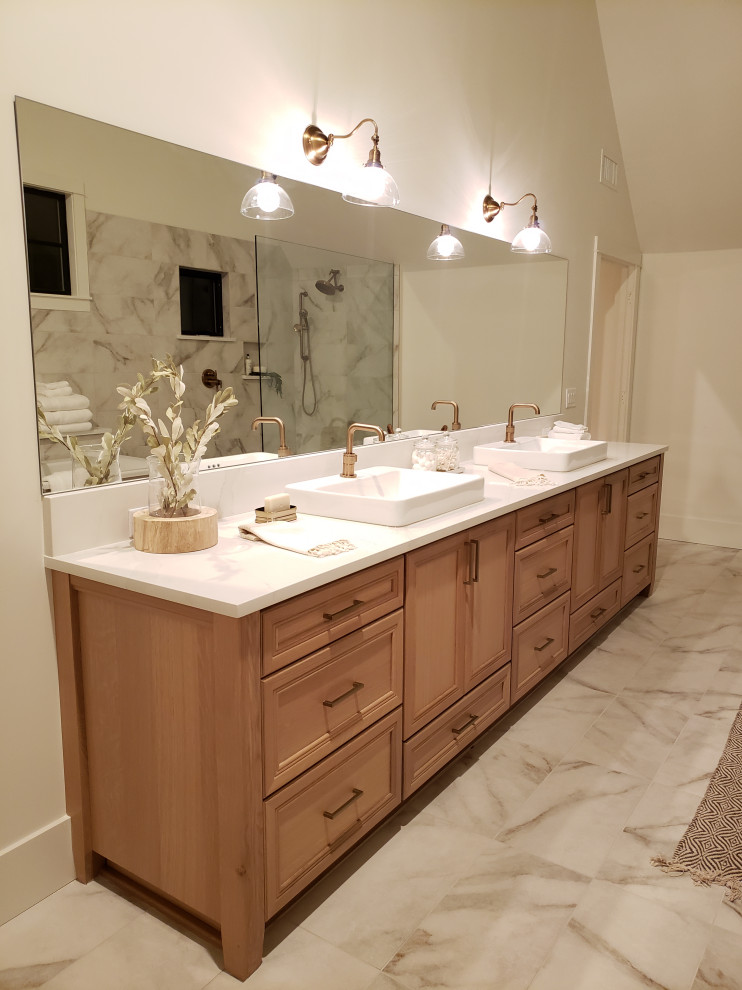 Photo of a large transitional master wet room bathroom in Portland with recessed-panel cabinets, brown cabinets, a freestanding tub, a two-piece toilet, white tile, marble, white walls, marble floors, a vessel sink, quartzite benchtops, white floor, an open shower, white benchtops, a double vanity and a freestanding vanity.