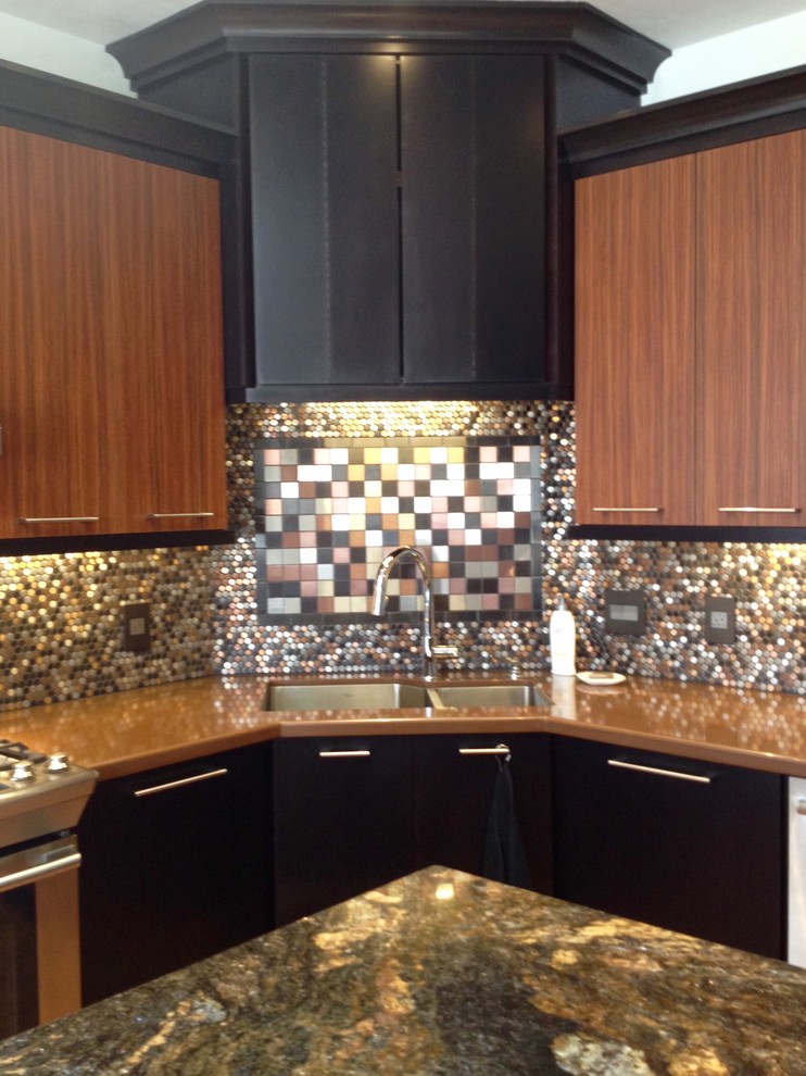 This is an example of a mid-sized modern l-shaped kitchen in Albuquerque with an undermount sink, granite benchtops, multi-coloured splashback, metal splashback, stainless steel appliances and with island.