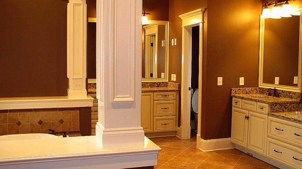 Master brown tile ceramic tile japanese bathtub photo with an undermount sink, recessed-panel cabinets, white cabinets, granite countertops and brown walls