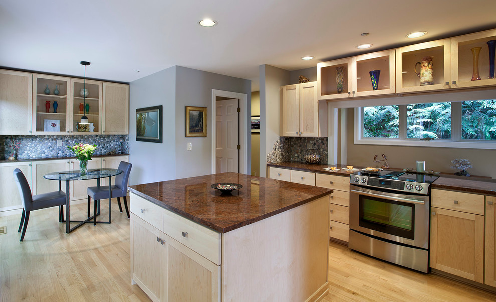 Photo of a transitional eat-in kitchen in Seattle with shaker cabinets, light wood cabinets, stone tile splashback and stainless steel appliances.