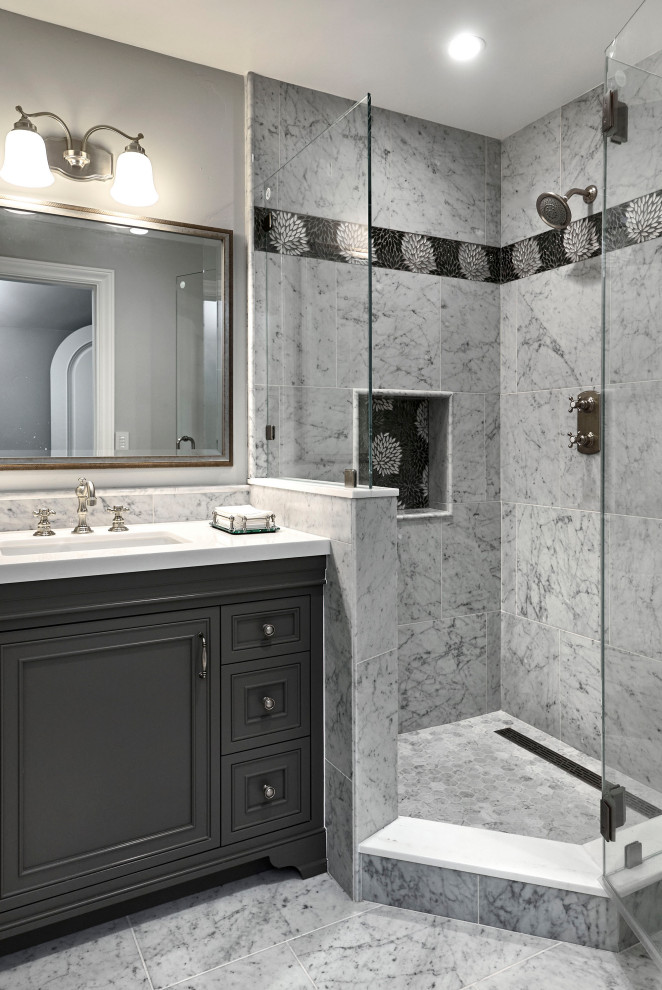 Photo of a mid-sized traditional 3/4 bathroom in San Francisco with beaded inset cabinets, grey cabinets, a corner shower, a two-piece toilet, white tile, marble, grey walls, marble floors, an undermount sink, marble benchtops, grey floor, a hinged shower door, white benchtops, a niche, a single vanity and a built-in vanity.