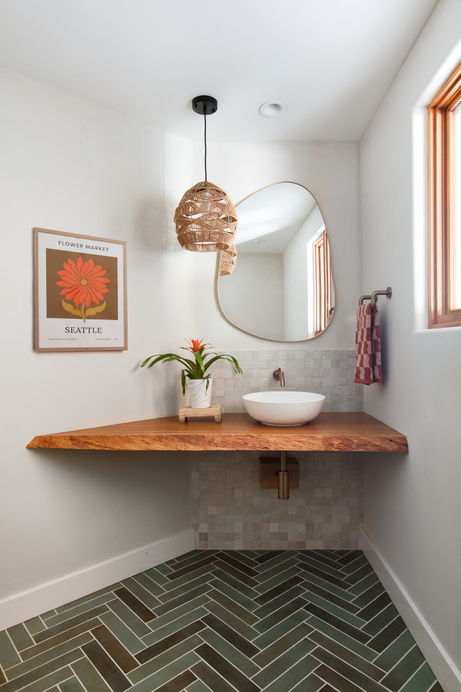 Small trendy white tile and ceramic tile porcelain tile and green floor powder room photo in San Diego with brown cabinets, a vessel sink, wood countertops and a floating vanity
