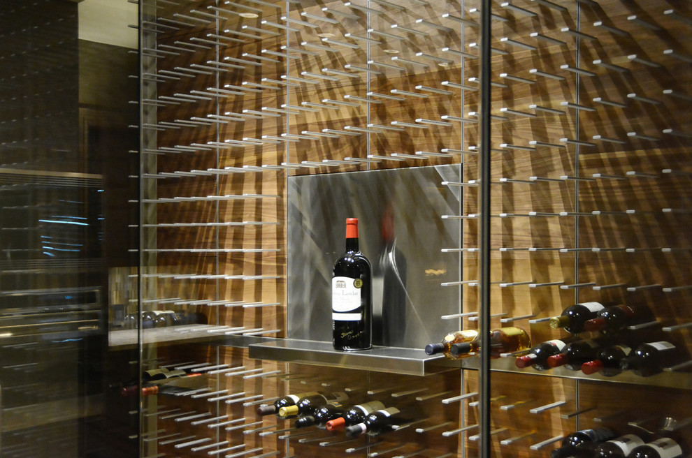Inspiration for a large contemporary wine cellar in Tampa with light hardwood floors and storage racks.