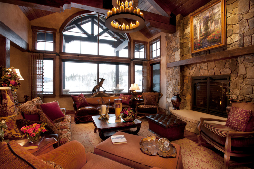 Large traditional enclosed living room in Denver with brown walls, medium hardwood floors, a standard fireplace and a stone fireplace surround.