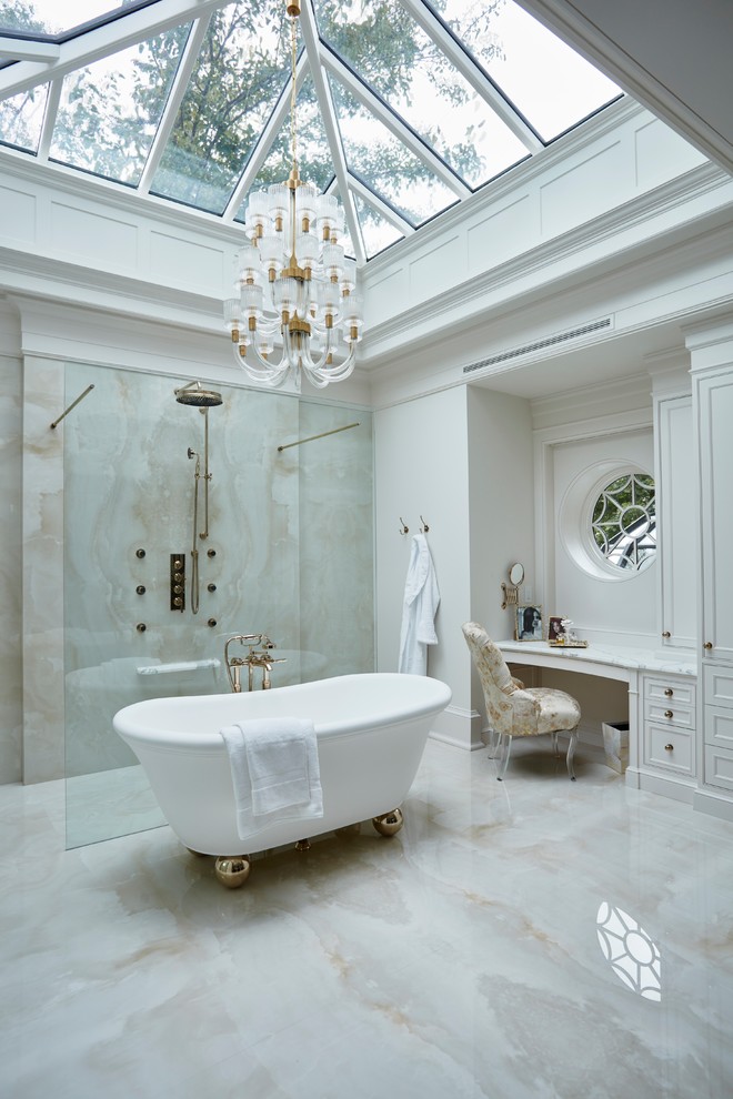 Expansive traditional master bathroom in Toronto with a freestanding tub, beige tile, marble, marble floors, marble benchtops, an open shower, recessed-panel cabinets, white cabinets, a curbless shower, white walls, beige floor and white benchtops.