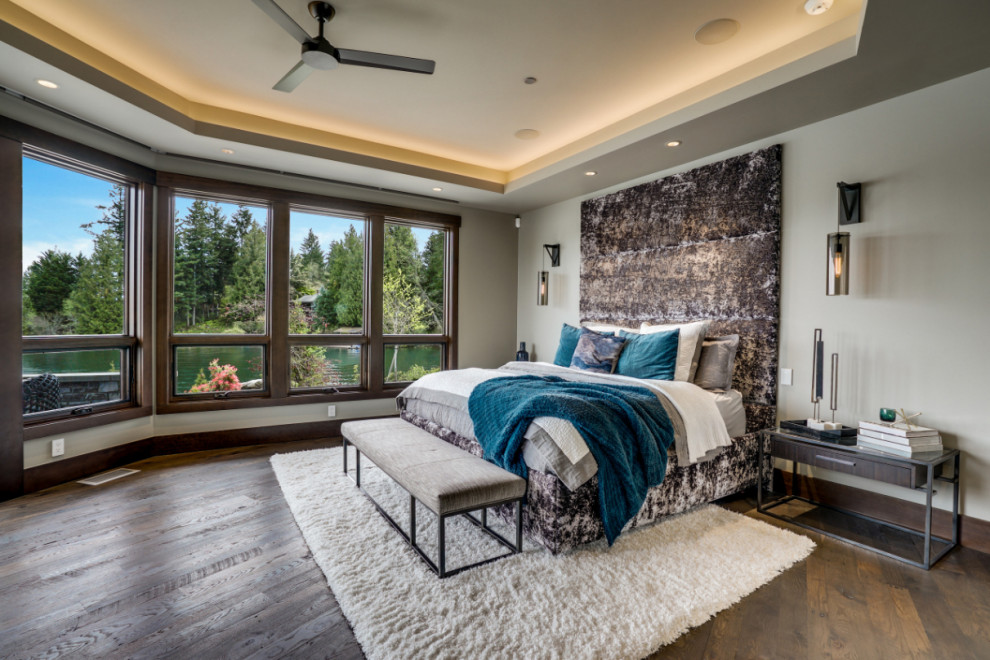 Design ideas for an expansive country master bedroom in Seattle with grey walls, dark hardwood floors, a ribbon fireplace, a metal fireplace surround, black floor and coffered.