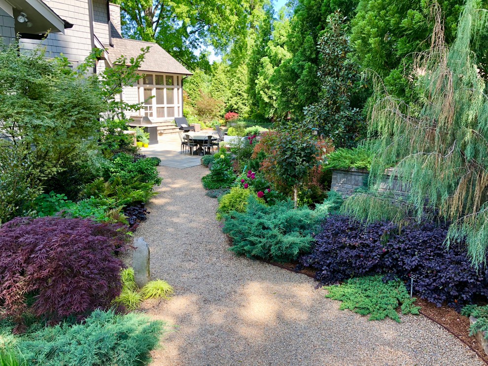 This is an example of an eclectic backyard garden in Charlotte.