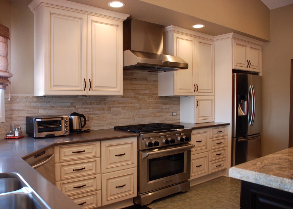 Inspiration for a mid-sized transitional u-shaped ceramic tile open concept kitchen remodel in Denver with an undermount sink, raised-panel cabinets, white cabinets, quartz countertops, beige backsplash, matchstick tile backsplash, stainless steel appliances and an island