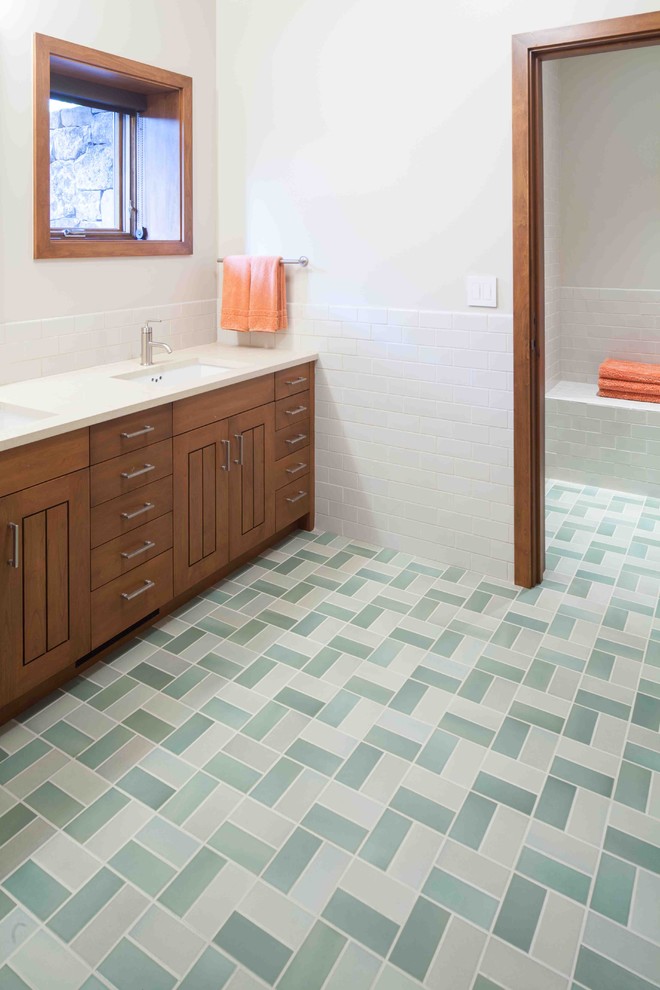 This is an example of a country bathroom in Portland with subway tile and green floor.