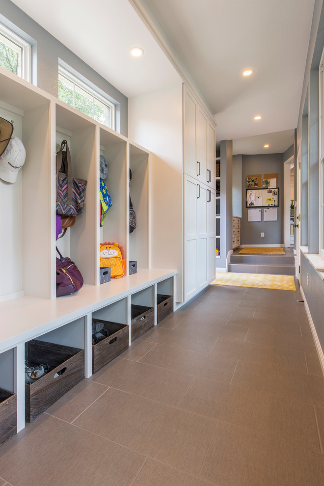 Example of a mid-sized transitional porcelain tile mudroom design in Austin with gray walls and a white front door