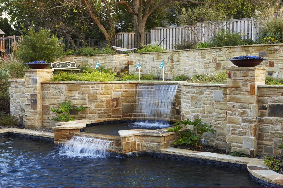 This is an example of a traditional backyard rectangular pool in Dallas with natural stone pavers.