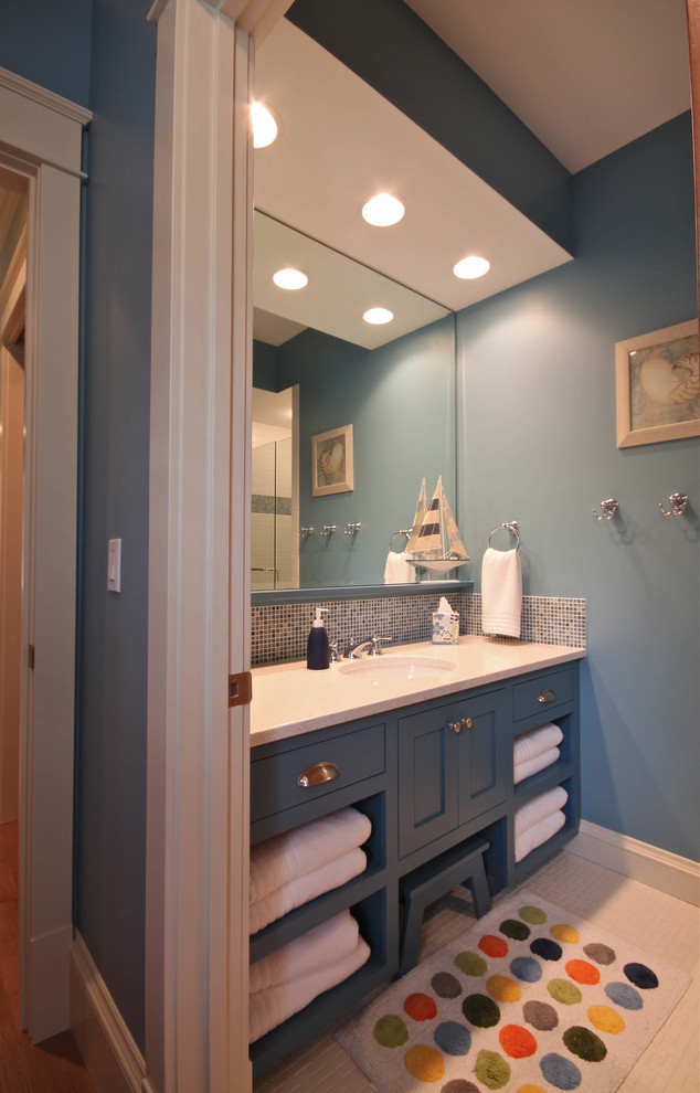 Design ideas for a transitional bathroom in Grand Rapids with an undermount sink, open cabinets, blue cabinets, engineered quartz benchtops, multi-coloured tile, glass tile, blue walls and mosaic tile floors.