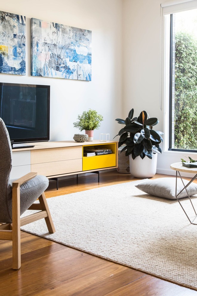 This is an example of a mid-sized contemporary open concept living room in Melbourne with white walls and medium hardwood floors.