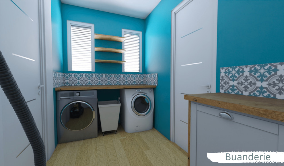This is an example of a mid-sized beach style l-shaped dedicated laundry room in Paris with open cabinets, wood benchtops, blue splashback, mosaic tile splashback, blue walls, bamboo floors, a side-by-side washer and dryer, beige floor and brown benchtop.