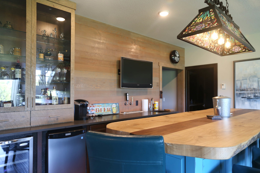Large transitional galley medium tone wood floor and brown floor home design photo with an undermount sink, wood countertops, brown backsplash, wood backsplash, glass-front cabinets and medium tone wood cabinets