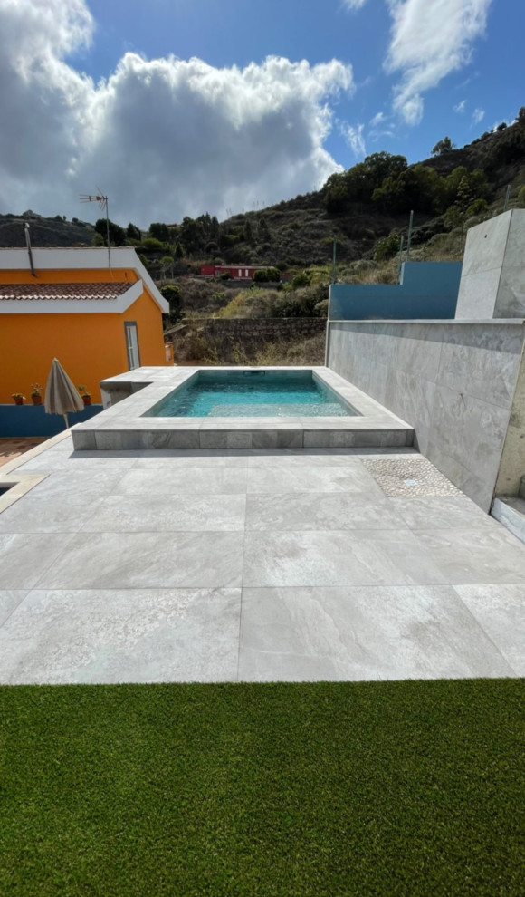 Inspiration for a mid-sized modern courtyard rectangular lap pool in Other with a pool house and tile.