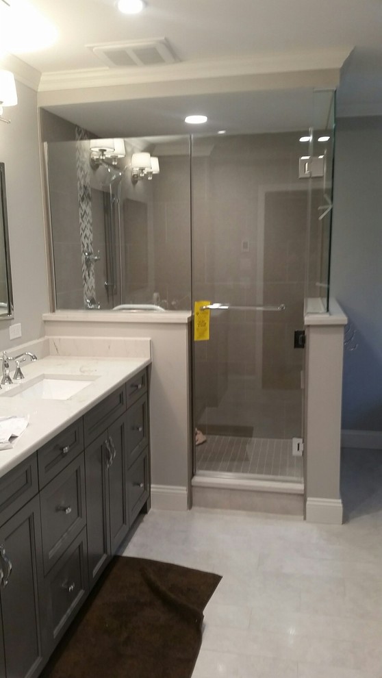 Mid-sized transitional 3/4 bathroom in Bridgeport with recessed-panel cabinets, a corner shower, beige walls, marble floors, an undermount sink, quartzite benchtops, grey floor and a hinged shower door.