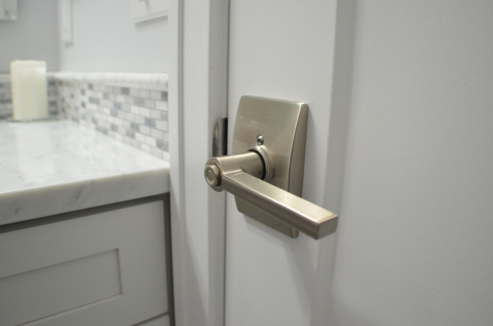 Inspiration for a transitional gray tile bathroom remodel with shaker cabinets, white cabinets and marble countertops
