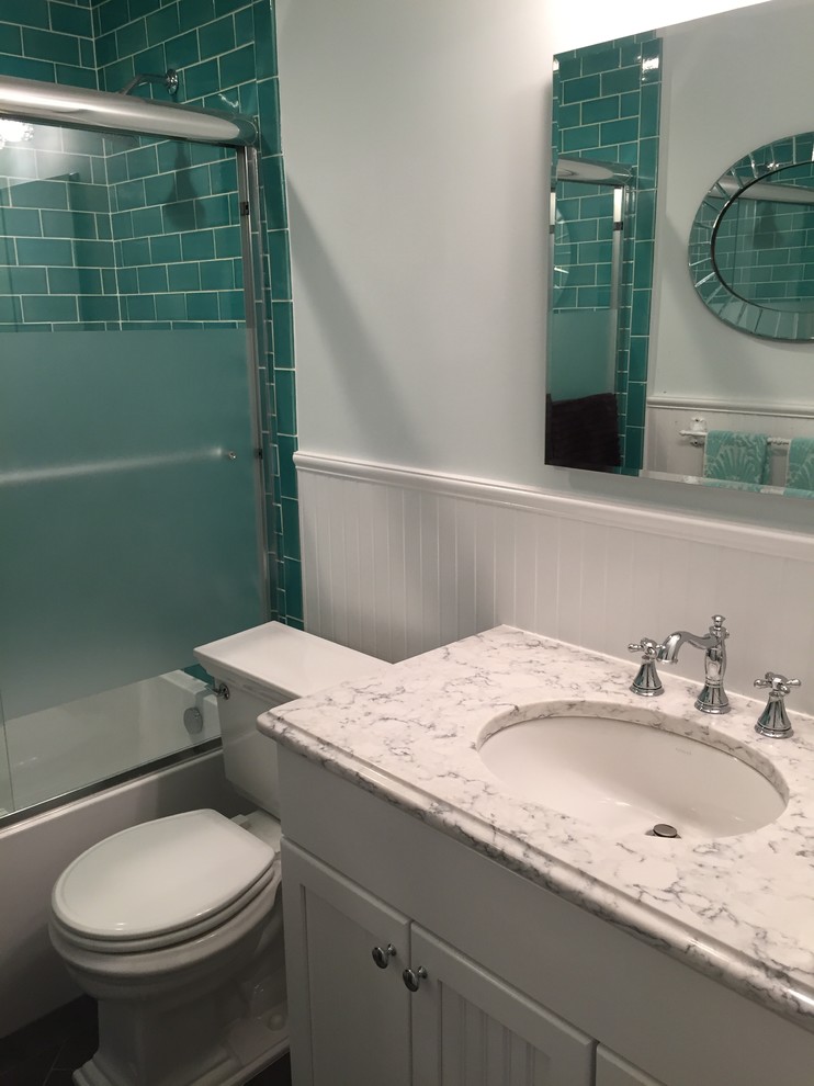 Small eclectic 3/4 bathroom in Newark with recessed-panel cabinets, white cabinets, an alcove tub, a two-piece toilet, green tile, ceramic tile, white walls, porcelain floors, an undermount sink, engineered quartz benchtops, grey floor and a sliding shower screen.