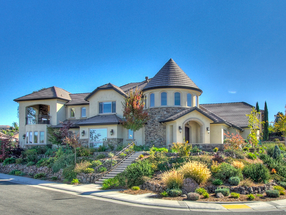This is an example of an expansive traditional two-storey multi-coloured house exterior in Sacramento with mixed siding, a hip roof and a shingle roof.
