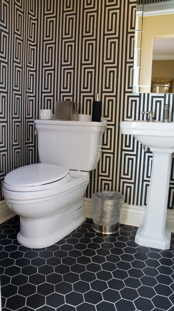 This is an example of a small traditional powder room in Denver with a two-piece toilet, gray tile, multi-coloured walls, porcelain floors and a pedestal sink.
