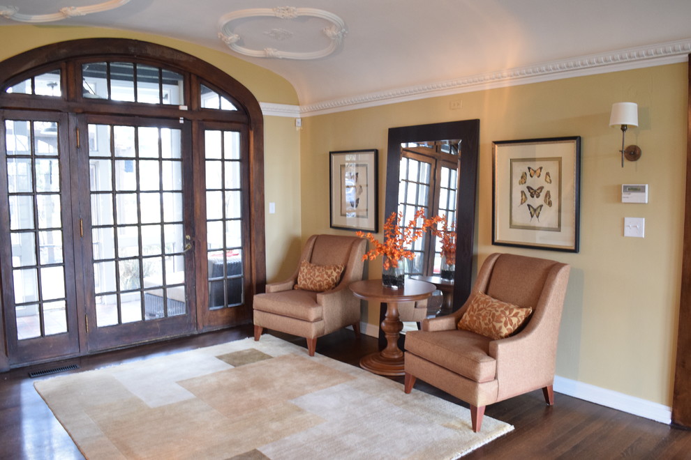 Entryway - mid-sized transitional dark wood floor and brown floor entryway idea in Other with yellow walls and a glass front door