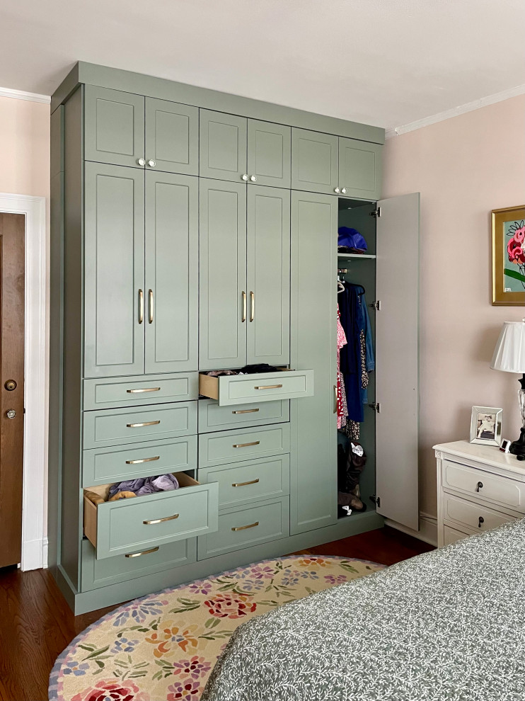 Inspiration for a small timeless women's dark wood floor and brown floor built-in closet remodel in Chicago with shaker cabinets
