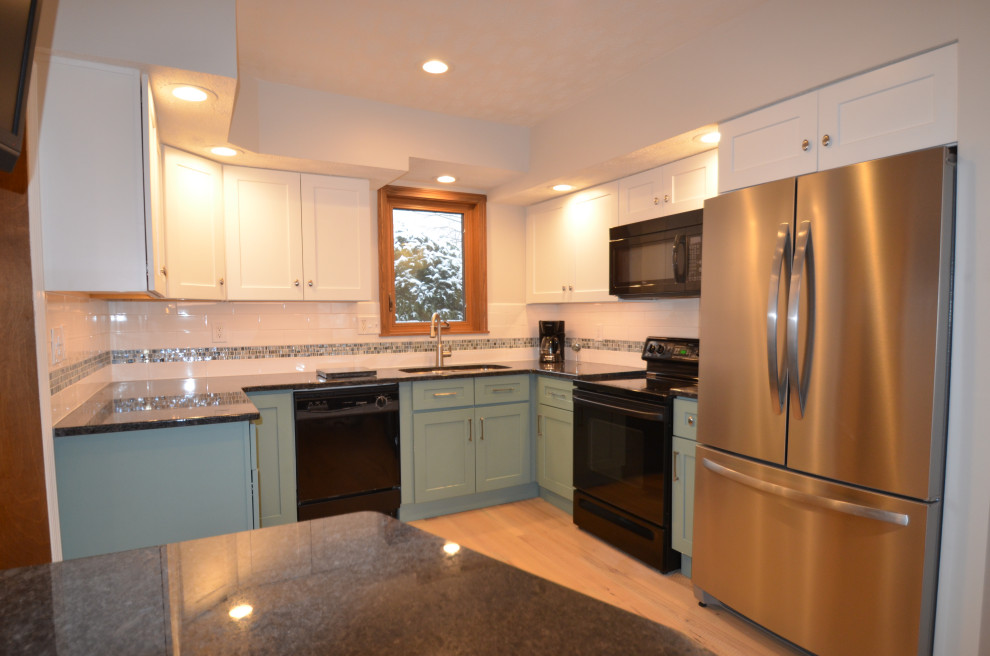Eat-in kitchen - mid-sized transitional u-shaped medium tone wood floor and brown floor eat-in kitchen idea with an undermount sink, raised-panel cabinets, beige cabinets, quartz countertops, white backsplash, subway tile backsplash, stainless steel appliances, an island and white countertops