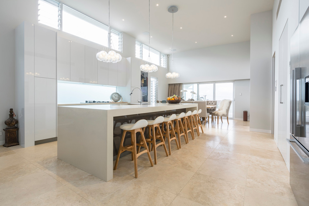 Inspiration for a large contemporary galley open plan kitchen in Sydney with flat-panel cabinets, white cabinets, quartz benchtops, mirror splashback, stainless steel appliances and with island.